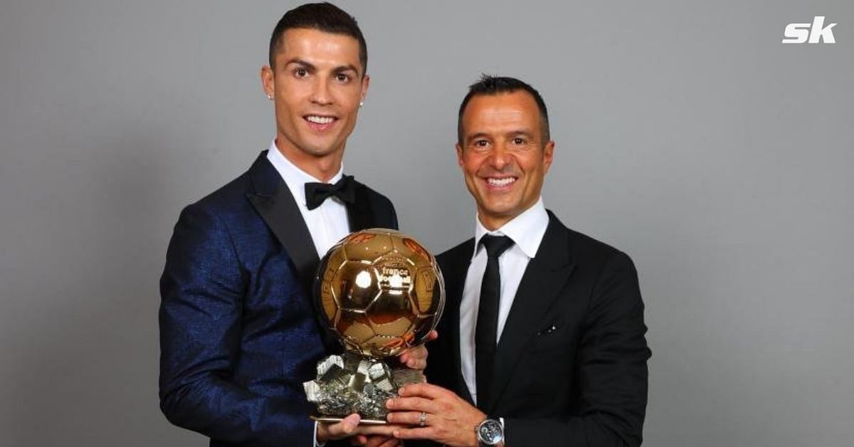 Ronaldo posing alongside Mendes with the Ballon d'Or
